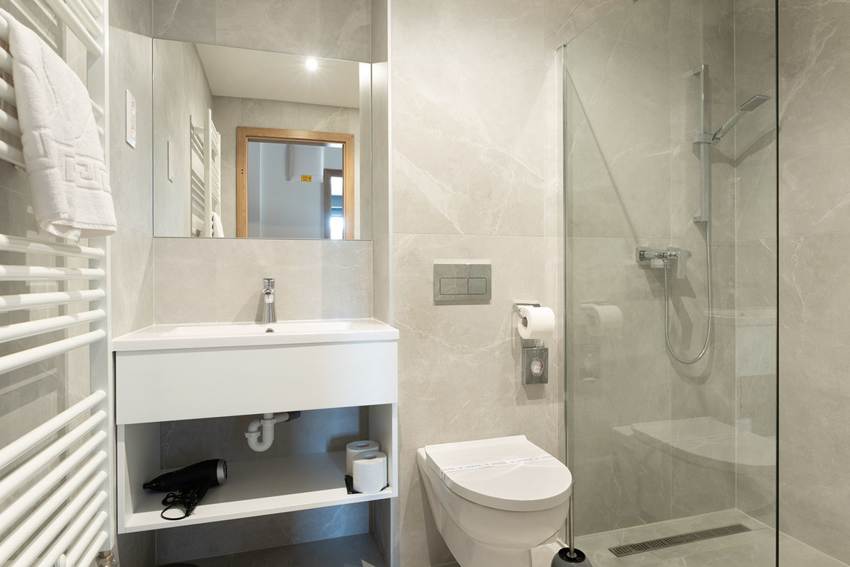 Shower bathroom with marble-look tile